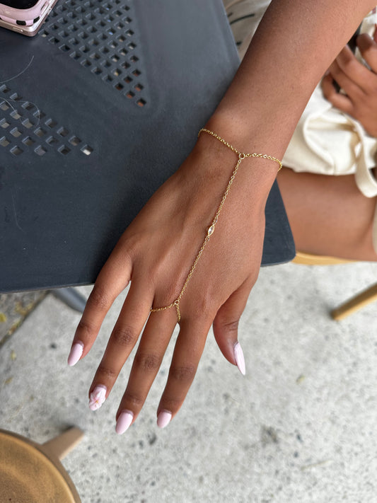 Delicate gold-filled hand chain with a marquise stone, worn on the hand with a slim ring loop and wrist chain. A dainty ring bracelet for layering or wearing solo, handmade in Brooklyn by Layer the Love.