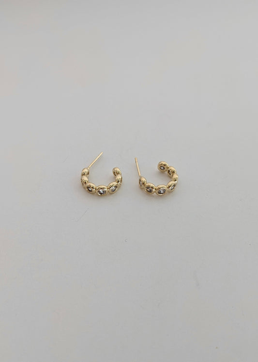 Gold-filled bezel huggie hoops with sparkling cubic zirconia. A comfortable everyday CZ huggie for stacking or wearing solo. Handmade in Brooklyn.