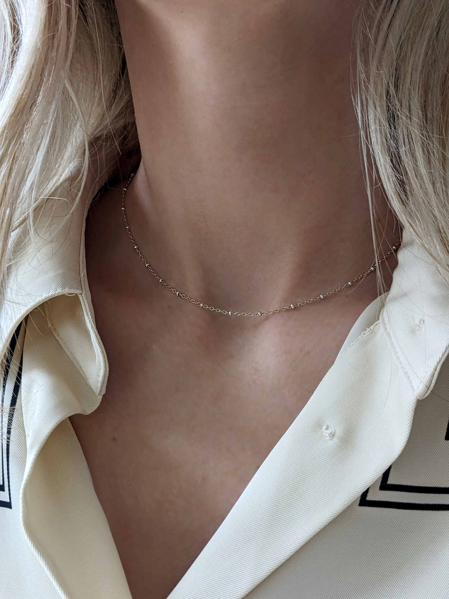 Delicate mixed metal satellite chain necklace in gold-filled and sterling silver. A dainty two-tone layering piece, handmade in Brooklyn by Layer the Love.