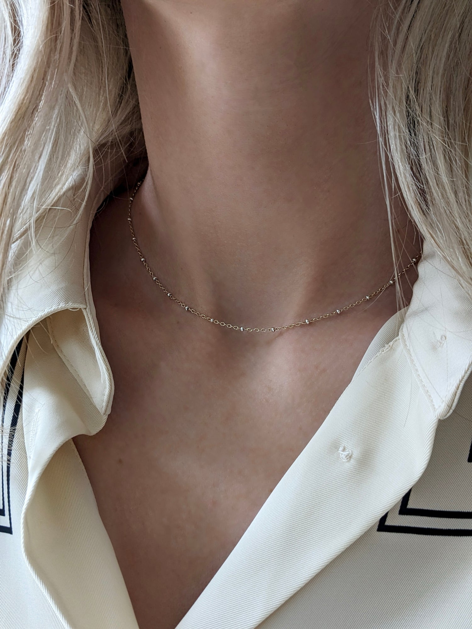 Delicate mixed metal satellite chain necklace in gold-filled and sterling silver. A dainty two-tone layering piece, handmade in Brooklyn by Layer the Love.