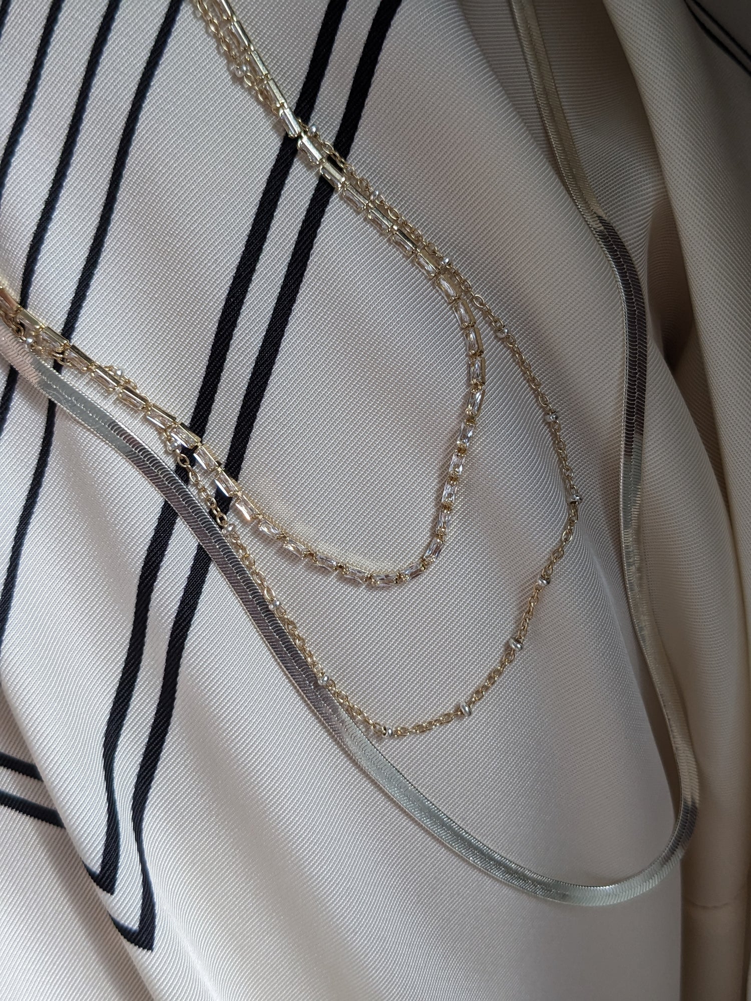 Delicate mixed metal satellite chain necklace in gold-filled and sterling silver. A dainty two-tone layering piece, handmade in Brooklyn by Layer the Love.