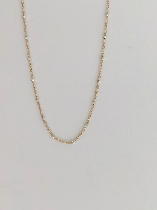 Delicate mixed metal satellite chain necklace in gold-filled and sterling silver. A dainty two-tone layering piece, handmade in Brooklyn by Layer the Love.