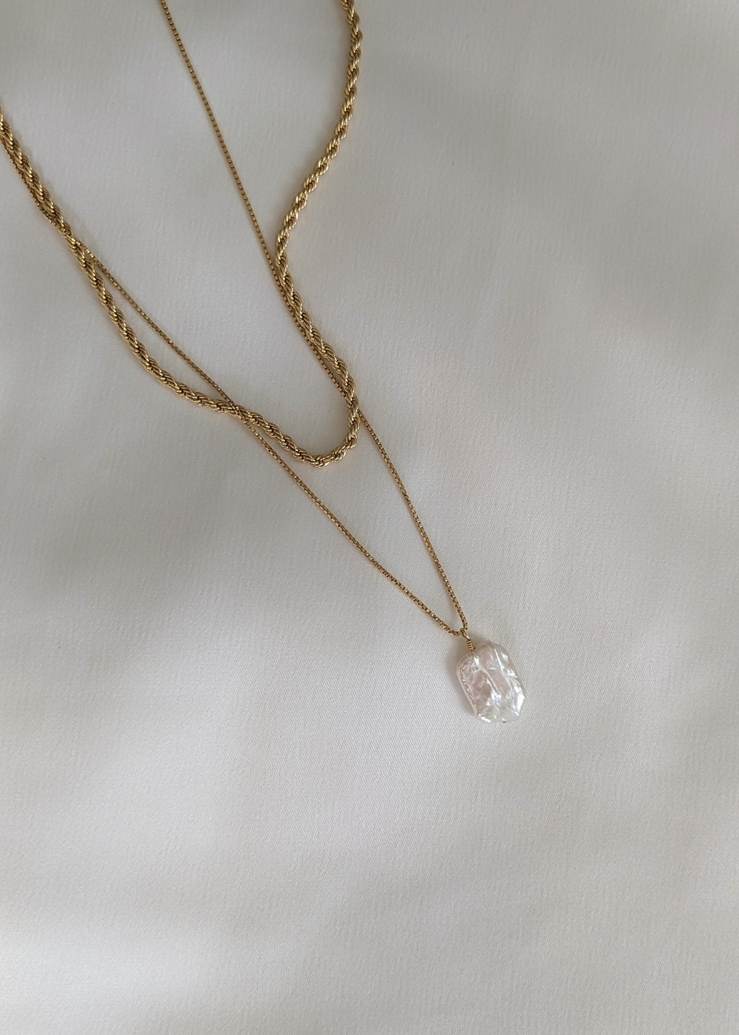  a gold filled necklace with a baroque pearl layered with a rope chain necklace