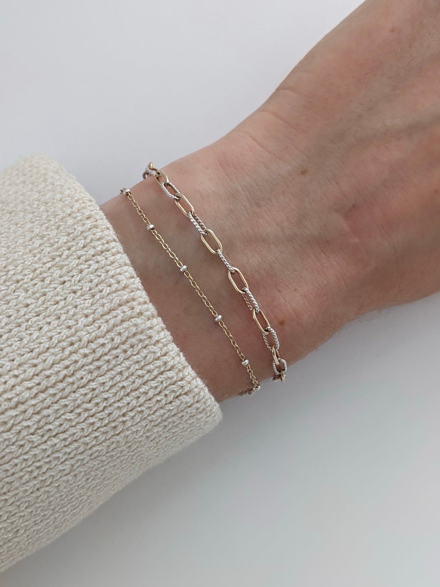Delicate mixed metal satellite chain bracelet in gold-filled and sterling silver. A dainty two-tone stacking bracelet, handmade in Brooklyn by Layer the Love.