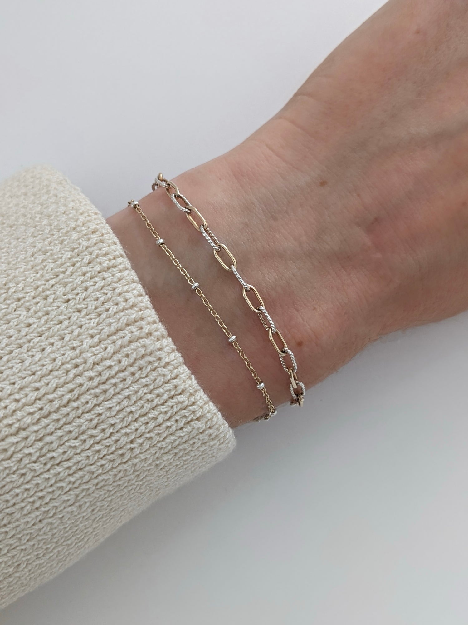 Delicate mixed metal satellite chain bracelet in gold-filled and sterling silver. A dainty two-tone stacking bracelet, handmade in Brooklyn by Layer the Love.